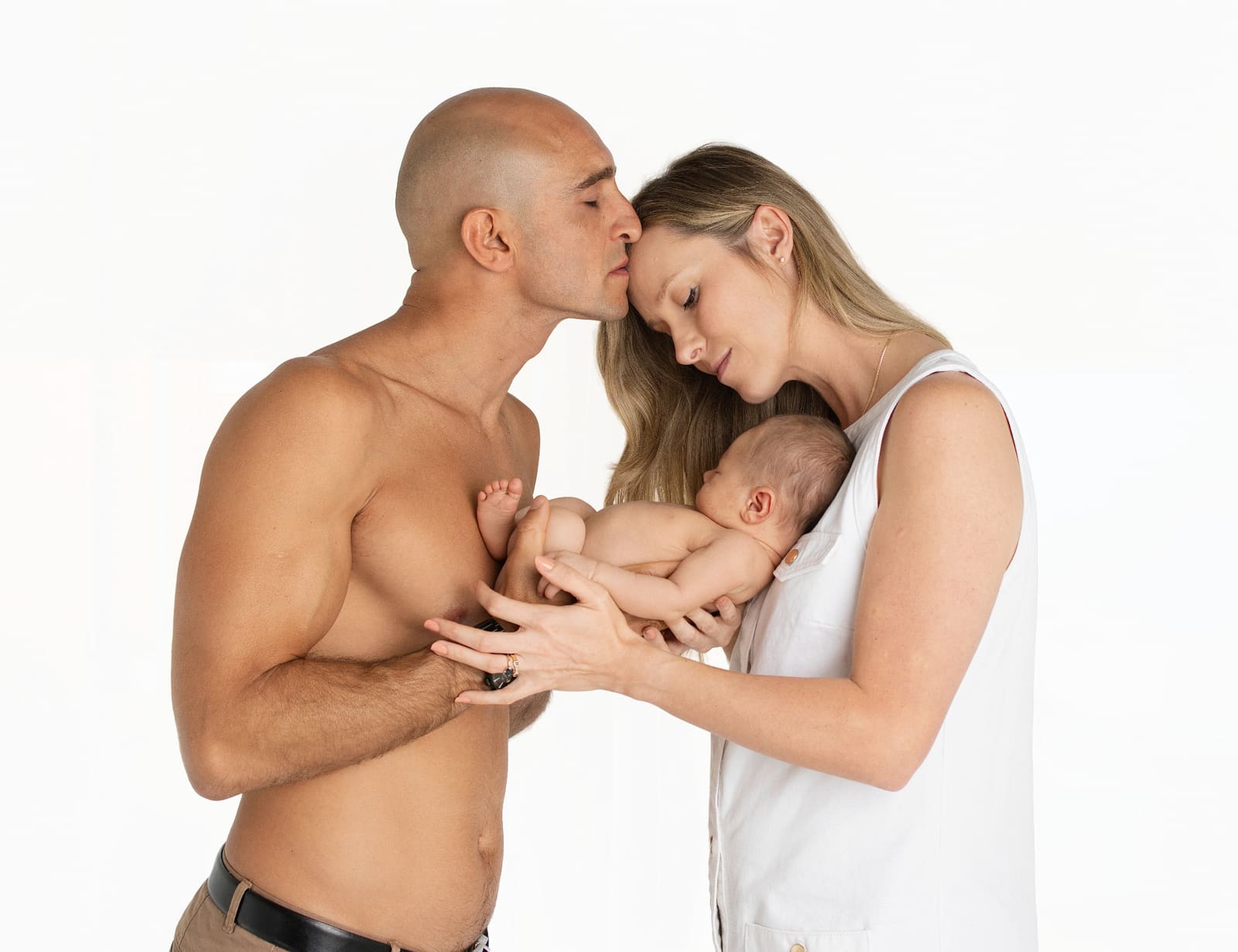 Family embracing their newborn — a quiet, close-in moment