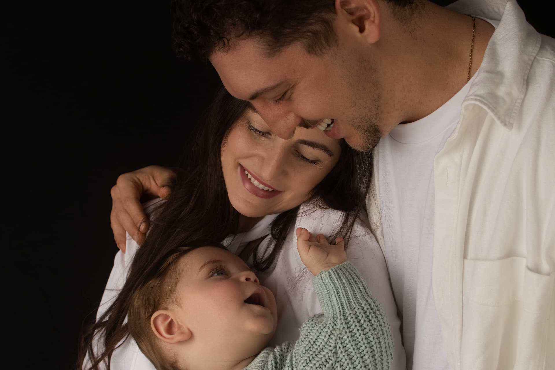Parents holding their baby close in the Mona Vale studio
