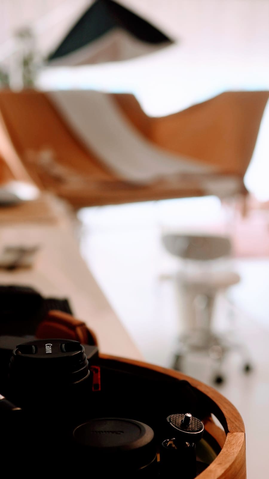 Studio detail of camera and printed frames on a neutral tray